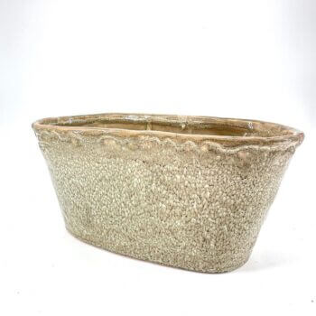 Elegant oval ceramic planter with speckled finish, perfect for indoor and outdoor plants.