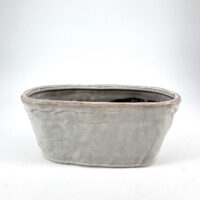 Elegant modern gray ceramic pot with glossy glaze, perfect for indoor plants or succulents.