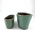 Handcrafted ceramic pots with turquoise glaze, showcasing unique textures and rustic charm.