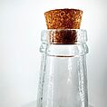 Elegant glass bottle with a cork stopper, showcasing craftsmanship and timeless design.
