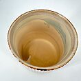 Handcrafted ceramic bowl, top view, showcasing earthy tones and unique artisan details.