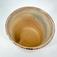 Handcrafted ceramic bowl, top view, showcasing earthy tones and unique artisan details.