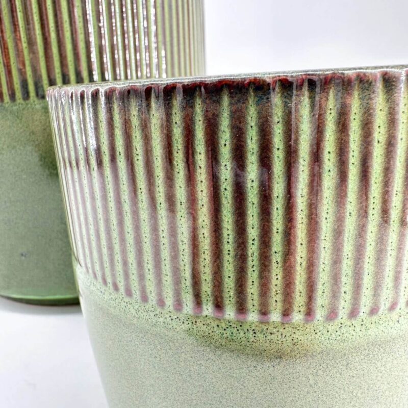 Modern Green and Red Ribbed Ceramic Planters Contemporary ceramic planters with green-red glaze, ribbed texture, showcasing modern craftsmanship.