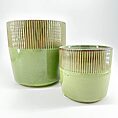Green ceramic pots with ribbed texture, glossy finish, set against white background.