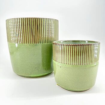 Green ceramic pots with ribbed texture, glossy finish, set against white background.