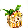 Whimsical building planter with lush green succulents and artistic architectural details.