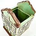 Charming mint green and terracotta ceramic house planter with rustic, whimsical design.
