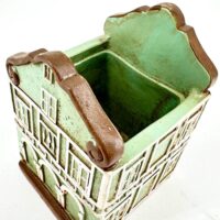 Charming mint green and terracotta ceramic house planter with rustic, whimsical design.