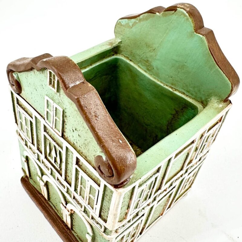 Whimsical Mint Green House Planter Charming mint green and terracotta ceramic house planter with rustic, whimsical design.