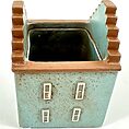Ceramic planter shaped like a house with blue and terracotta colours.