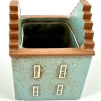 Ceramic planter shaped like a house with blue and terracotta colours.
