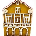 Miniature yellow building with red roof, whimsical decorative piece, ceramic architectural art.