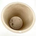 Minimalist ceramic pot top view, beige, smooth finish, ideal decorative planter.