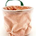 Pastel pink storage basket with green handle, featuring vertical stripes and cosy, textured fabric.