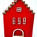 Stylized red house model with zigzag roof, grid windows, and white arched door.