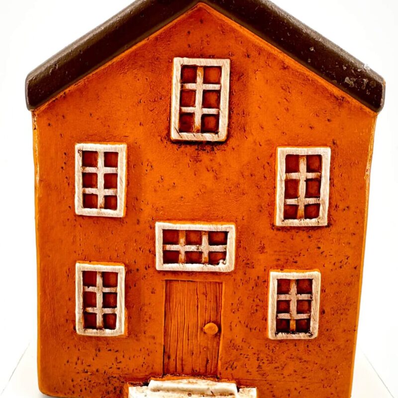 Charming Rustic Orange House Figurine Charming miniature orange house figurine with rustic details and contrasting white framed windows.