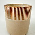 Two-toned ceramic pot with ribbed texture and glossy interior.