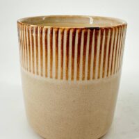 Two-toned ceramic pot with ribbed texture and glossy interior.