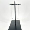 Minimalist black metal test tube holder, perfect for laboratory or decorative use.