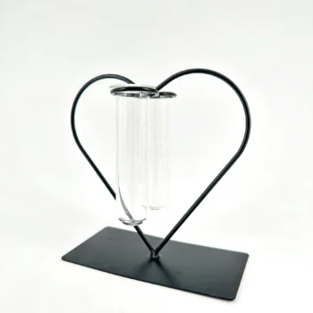 Heart-shaped metal frame with glass test tubes, blending science and romance in decorative art.
