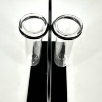Modern test tube holder with two glass tubes on sleek black base, minimalist design.