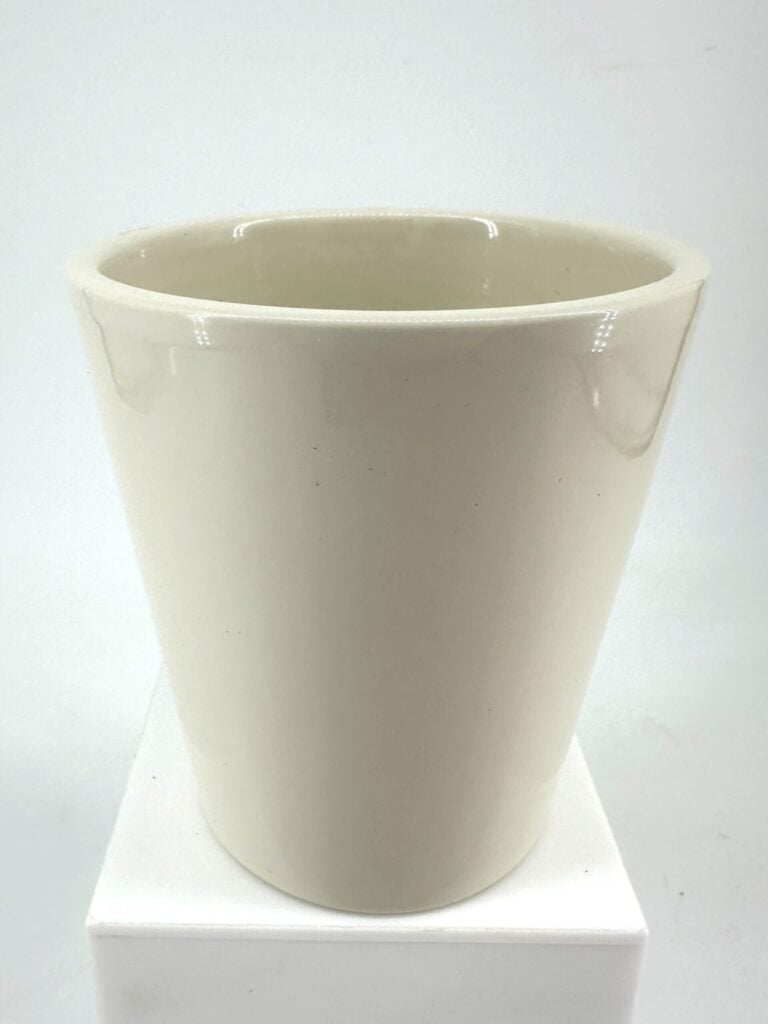 Elegant tapered white ceramic pot with glossy finish on a white pedestal.