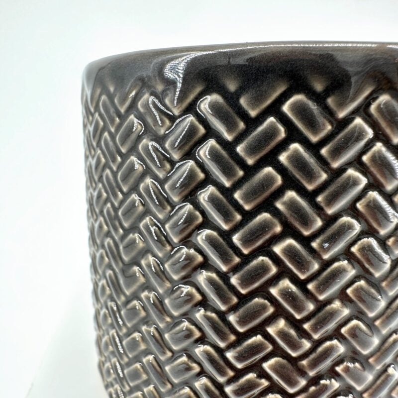 Geometric Textured Ceramic Planter with Glossy Finish Textured ceramic planter with geometric pattern, glossy dark finish, modern home decor.