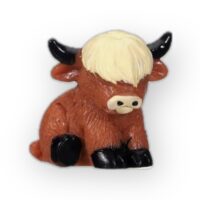 Miniature Highland cow figurine with fluffy coat and detailed features, perfect for collectors.