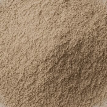 Macro close-up of fine beige powder texture with soft mound and matte, velvety granules.