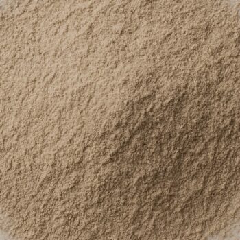 Macro close-up of fine beige powder texture with soft mound and matte, velvety granules.